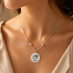 Silberne personalisierte Edelstahl Halskette mit rundem Anhänger, Auge des Horus Symbol und Gravur „Elena“, am Hals getragen